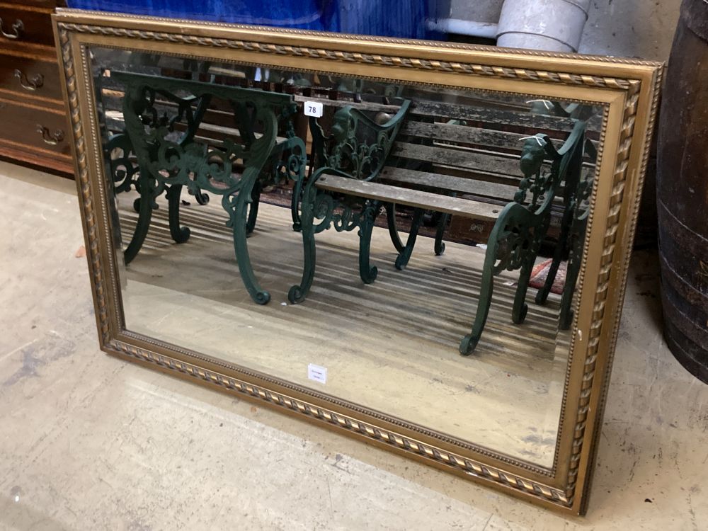 A modern gilt carved wood framed landscape wall mirror, width 116cm height 79cm